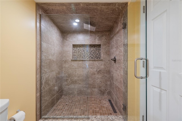 bathroom featuring an enclosed shower and toilet