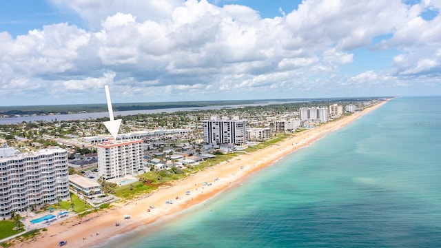 bird's eye view with a water view and a beach view