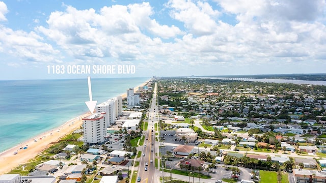 bird's eye view with a water view and a beach view