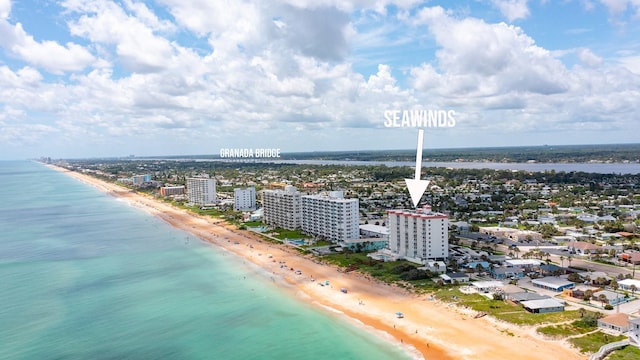 drone / aerial view with a beach view and a water view