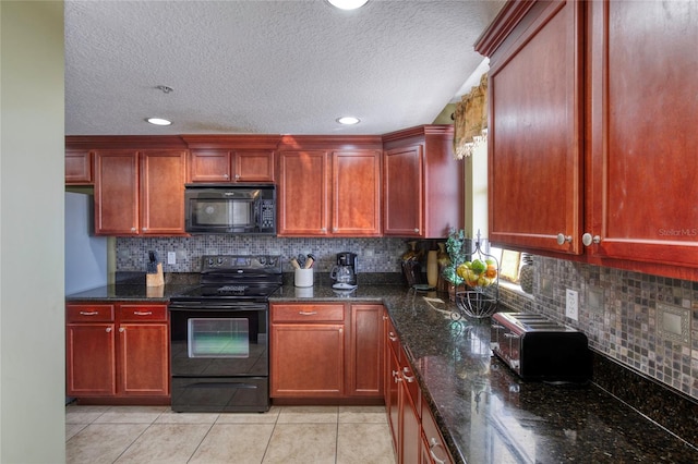 kitchen with dark stone counters, tasteful backsplash, light tile patterned floors, and black appliances