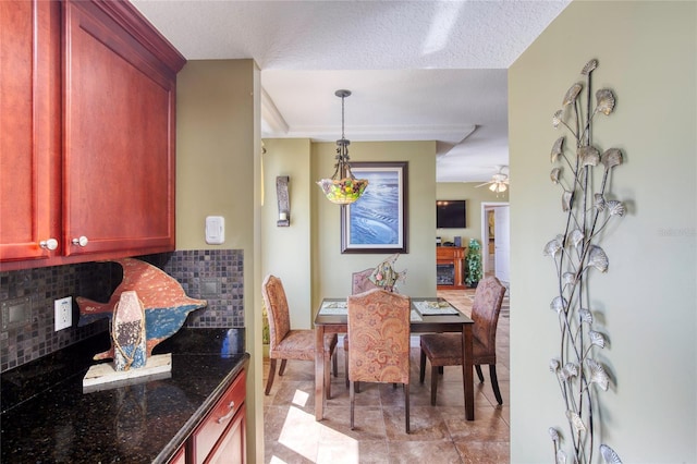 dining area with ceiling fan and a textured ceiling