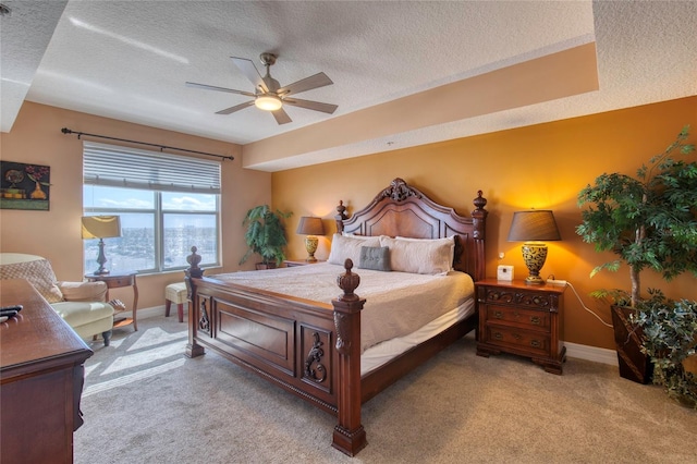 bedroom with a textured ceiling, ceiling fan, and light carpet