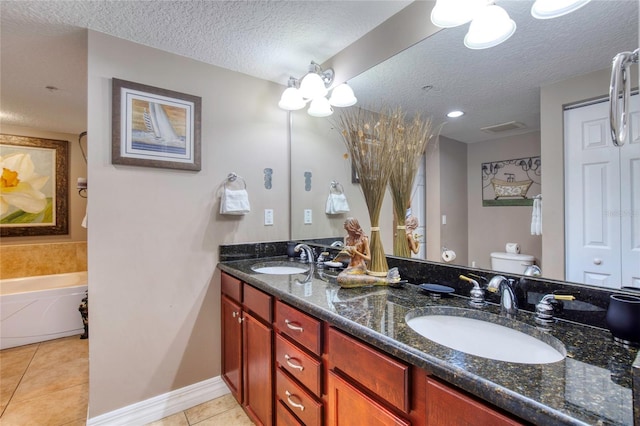 bathroom with vanity, a bathtub, tile patterned flooring, toilet, and a textured ceiling