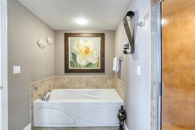 bathroom with a bath and a textured ceiling