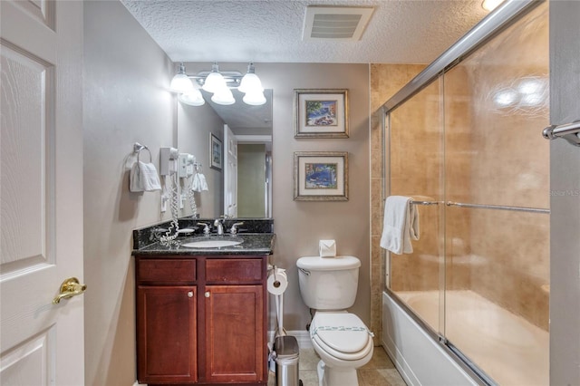 full bathroom with vanity, a textured ceiling, enclosed tub / shower combo, tile patterned flooring, and toilet