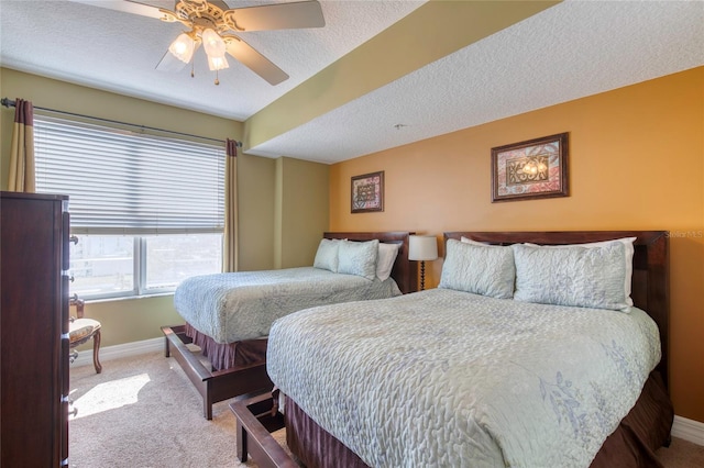 bedroom with light carpet, a textured ceiling, and ceiling fan