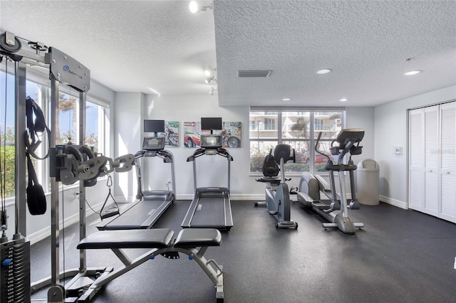 gym with a textured ceiling