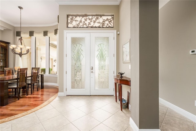 doorway to outside with french doors, tile patterned floors, and crown molding