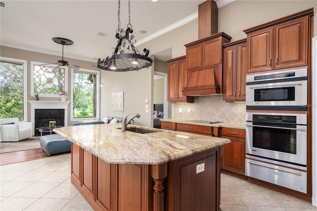 kitchen with double oven, black electric cooktop, a sink, custom exhaust hood, and a warming drawer