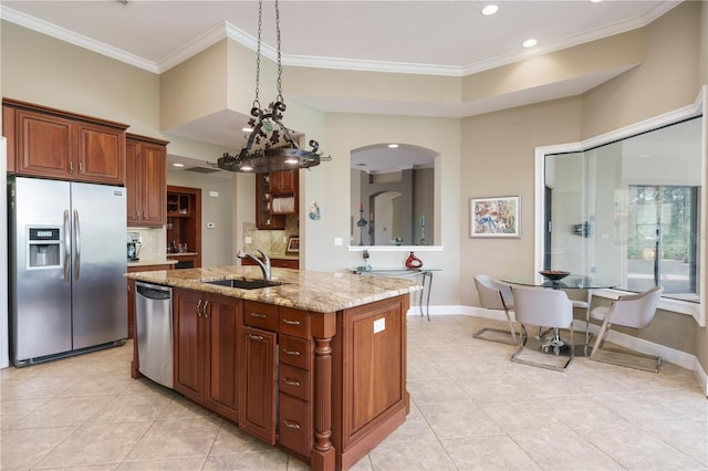 kitchen featuring light stone countertops, crown molding, stainless steel appliances, and a sink