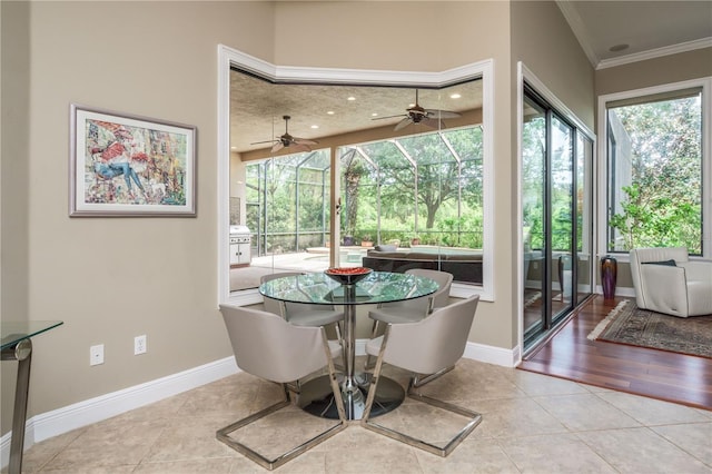 dining room with ornamental molding, tile patterned flooring, a sunroom, and a healthy amount of sunlight