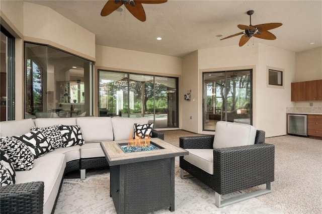 interior space with recessed lighting, beverage cooler, a ceiling fan, and light colored carpet