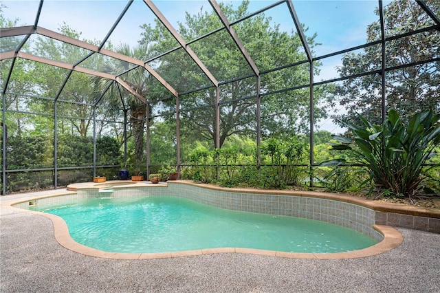 view of pool featuring a lanai, a patio area, and a pool with connected hot tub