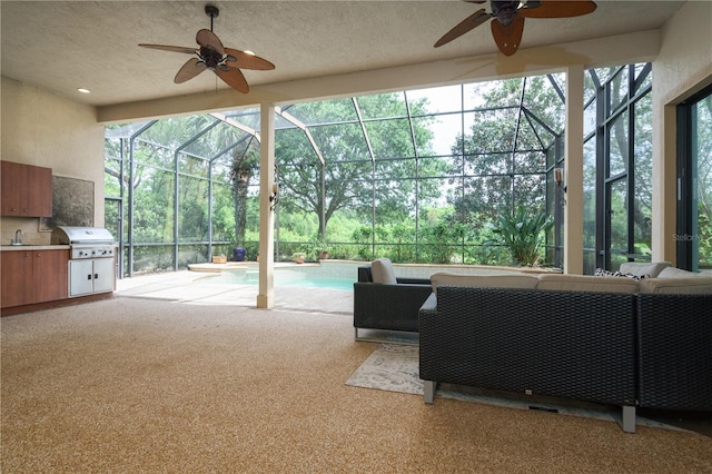 living area with a sunroom, carpet flooring, and a textured ceiling