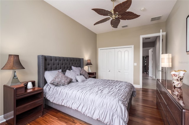 bedroom with a closet, visible vents, ceiling fan, wood finished floors, and baseboards