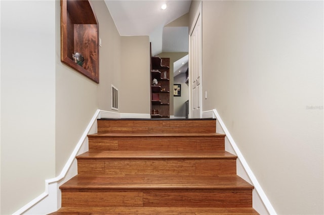 stairway with visible vents and baseboards