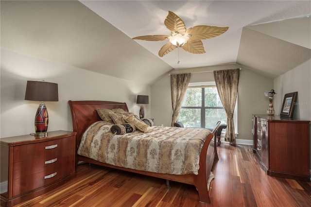 bedroom featuring dark wood-style floors, vaulted ceiling, baseboards, and ceiling fan