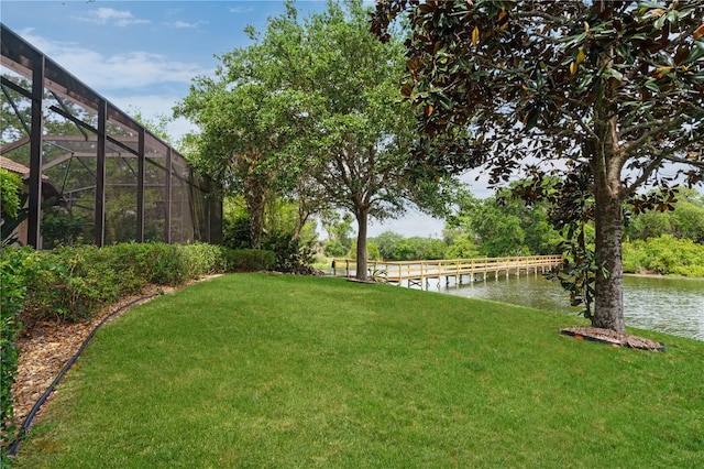 view of yard with a water view and a lanai