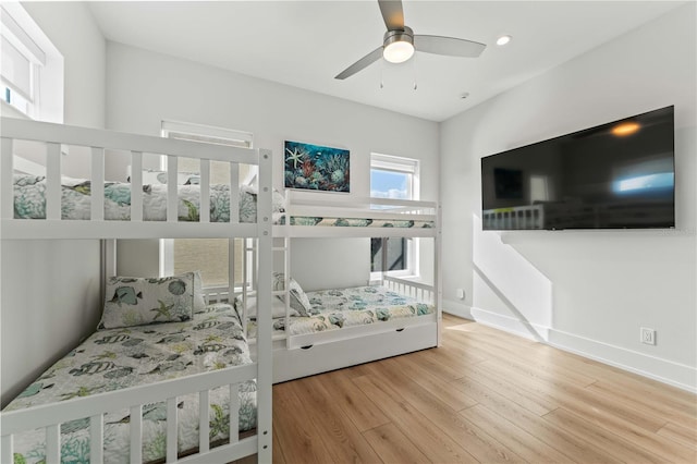 bedroom with hardwood / wood-style floors and ceiling fan