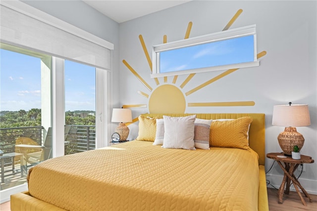 bedroom featuring hardwood / wood-style floors and access to outside