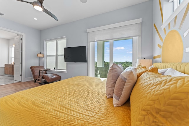 bedroom featuring access to exterior, connected bathroom, hardwood / wood-style flooring, and ceiling fan