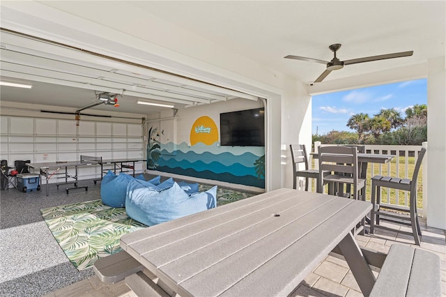 garage featuring ceiling fan and a garage door opener