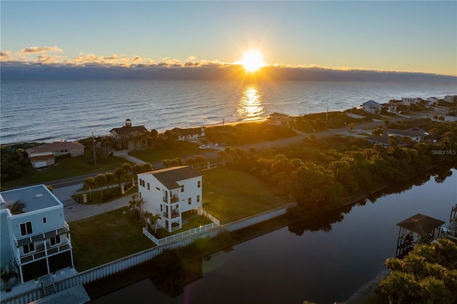 aerial view at dusk with a water view