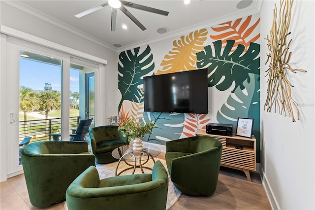 living room featuring wood-type flooring, ceiling fan, and ornamental molding