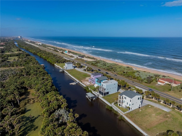 birds eye view of property with a water view and a view of the beach