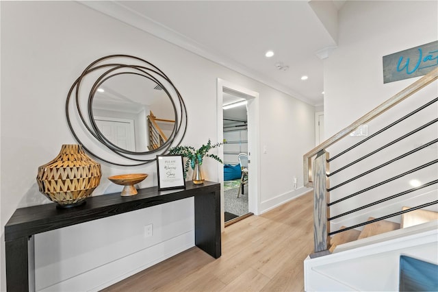 foyer with crown molding and light wood-type flooring