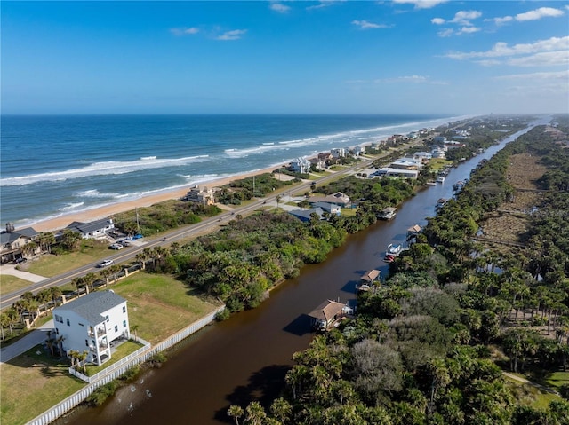 drone / aerial view featuring a water view and a beach view