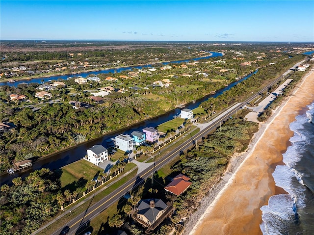 drone / aerial view featuring a water view and a beach view