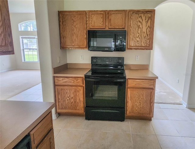 kitchen with light tile patterned floors and black appliances