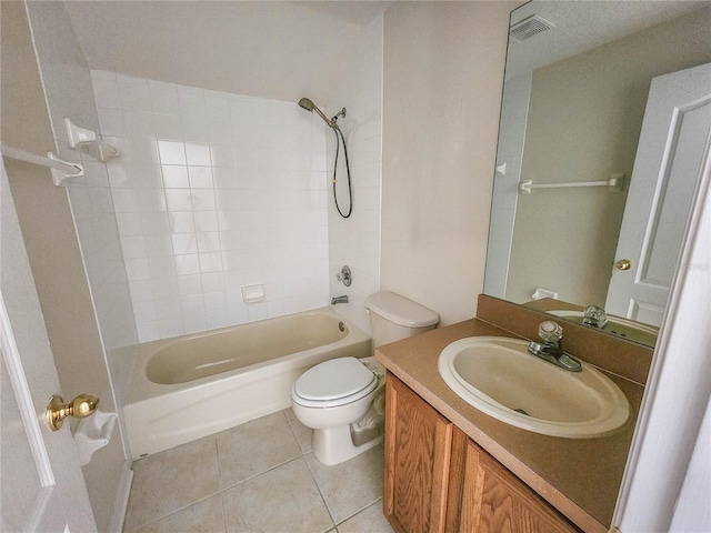 full bathroom featuring tile patterned flooring, vanity, tiled shower / bath combo, and toilet