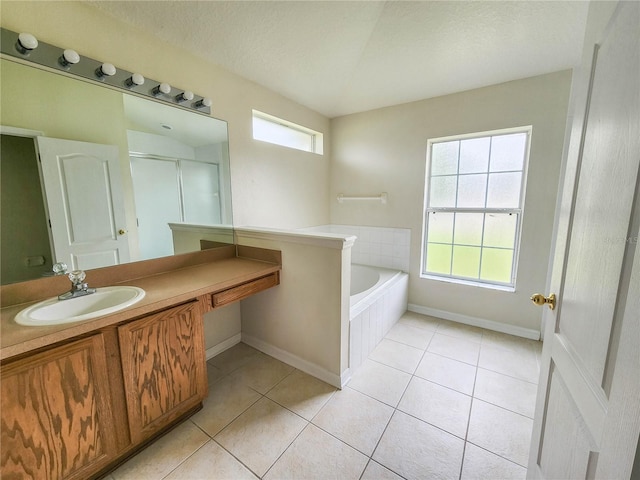 bathroom with tile patterned floors, vanity, independent shower and bath, and a textured ceiling