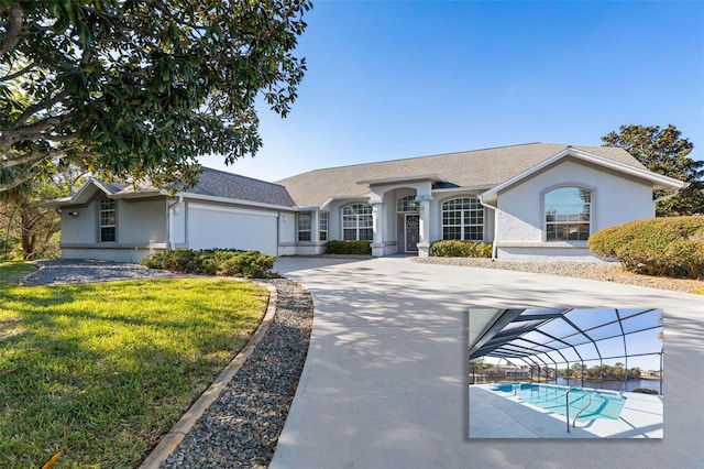 ranch-style house featuring a front yard and a garage