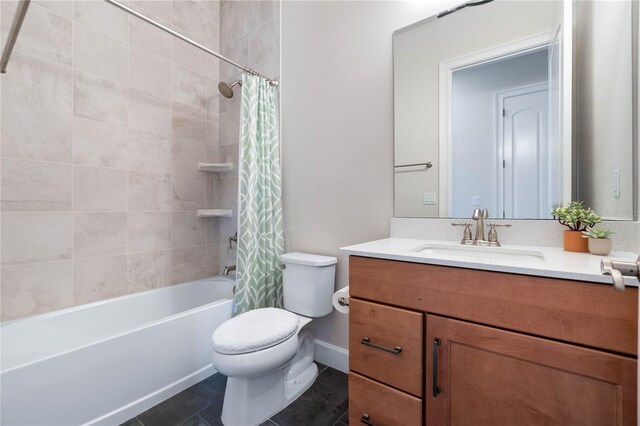 full bathroom featuring tile patterned floors, vanity, toilet, and shower / bath combo with shower curtain