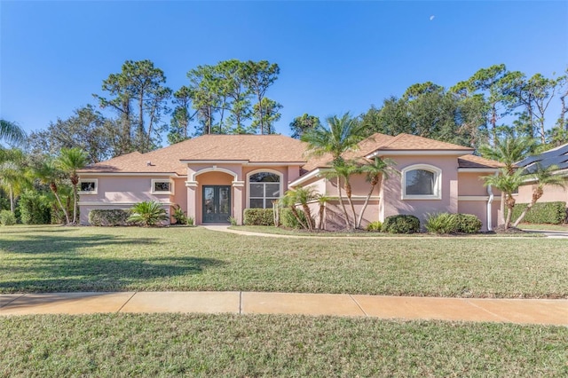 mediterranean / spanish home with a front yard