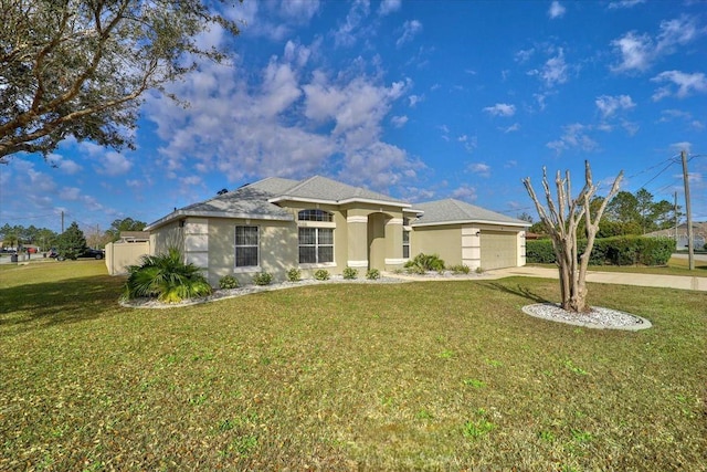 view of front of home with a garage and a front lawn