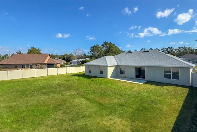 rear view of property with a patio and a yard