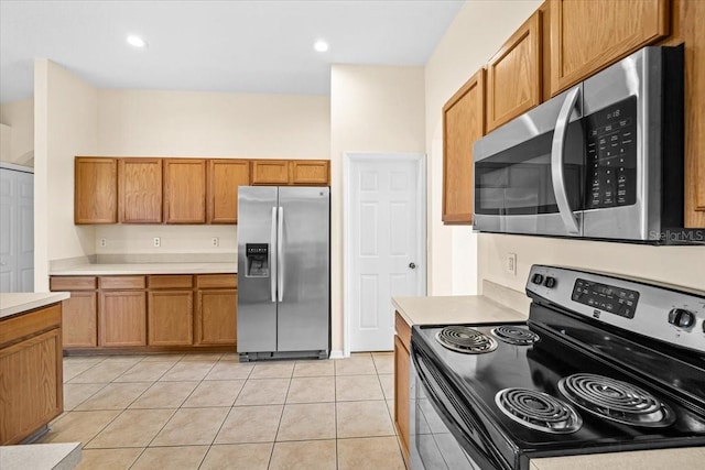 kitchen featuring light tile patterned floors and appliances with stainless steel finishes