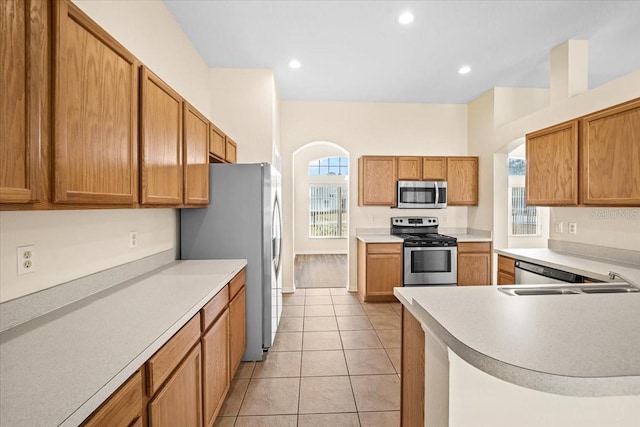 kitchen featuring sink, light tile patterned floors, and appliances with stainless steel finishes