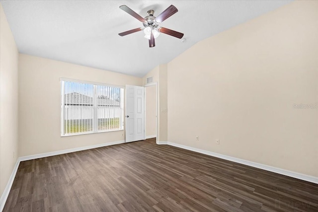 spare room featuring lofted ceiling, dark hardwood / wood-style floors, and ceiling fan