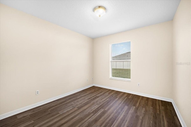 unfurnished room featuring dark wood-type flooring