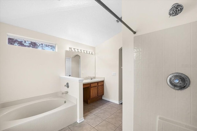 bathroom with vanity, tiled bath, and tile patterned flooring