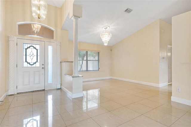 entrance foyer with plenty of natural light, ornate columns, and a chandelier