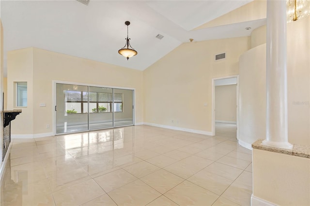 unfurnished living room with ornate columns, high vaulted ceiling, and light tile patterned floors