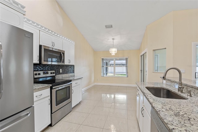 kitchen with sink, white cabinetry, stainless steel appliances, and vaulted ceiling