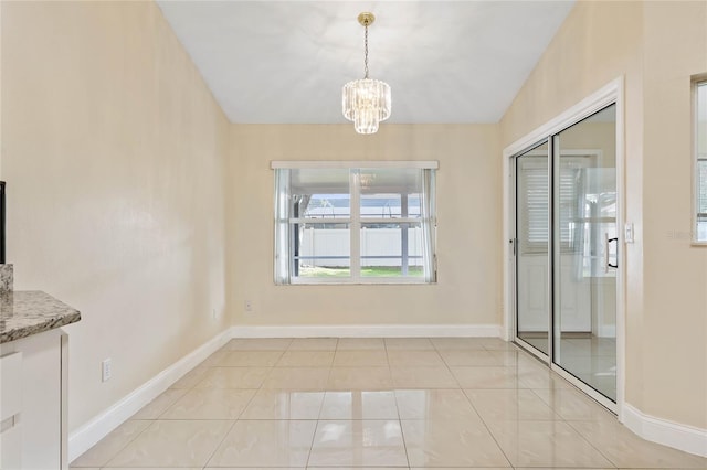 unfurnished dining area with light tile patterned floors, lofted ceiling, and an inviting chandelier